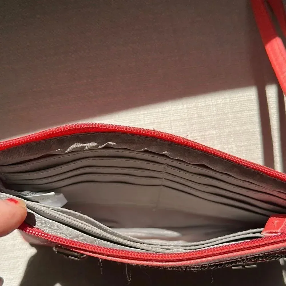 Nicole by Nicole Miller salmon colored Wristlet with Gold Details